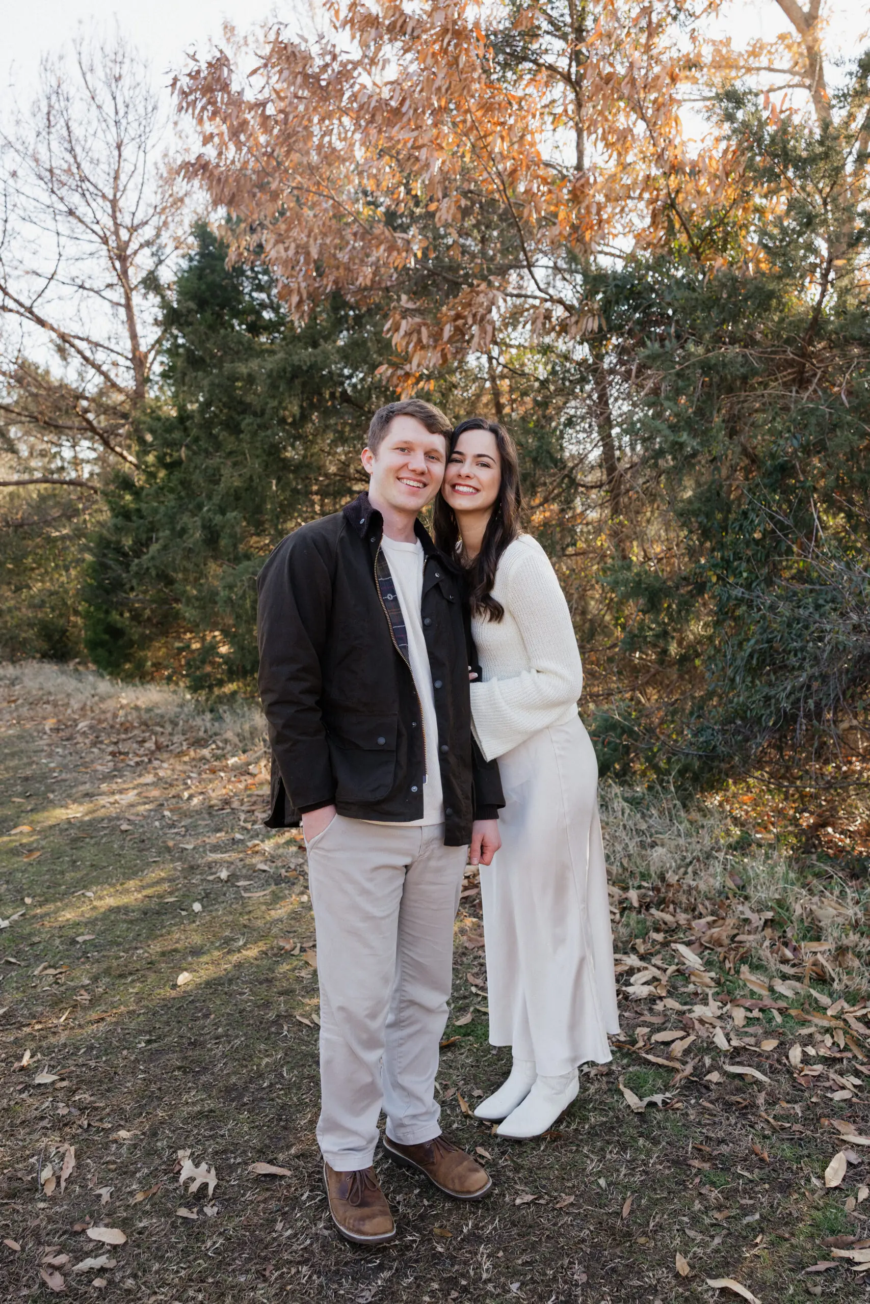 Couple standing together in tall grass at Bells Mill Park in Chesapeake, Virginia, sharing a quiet moment.