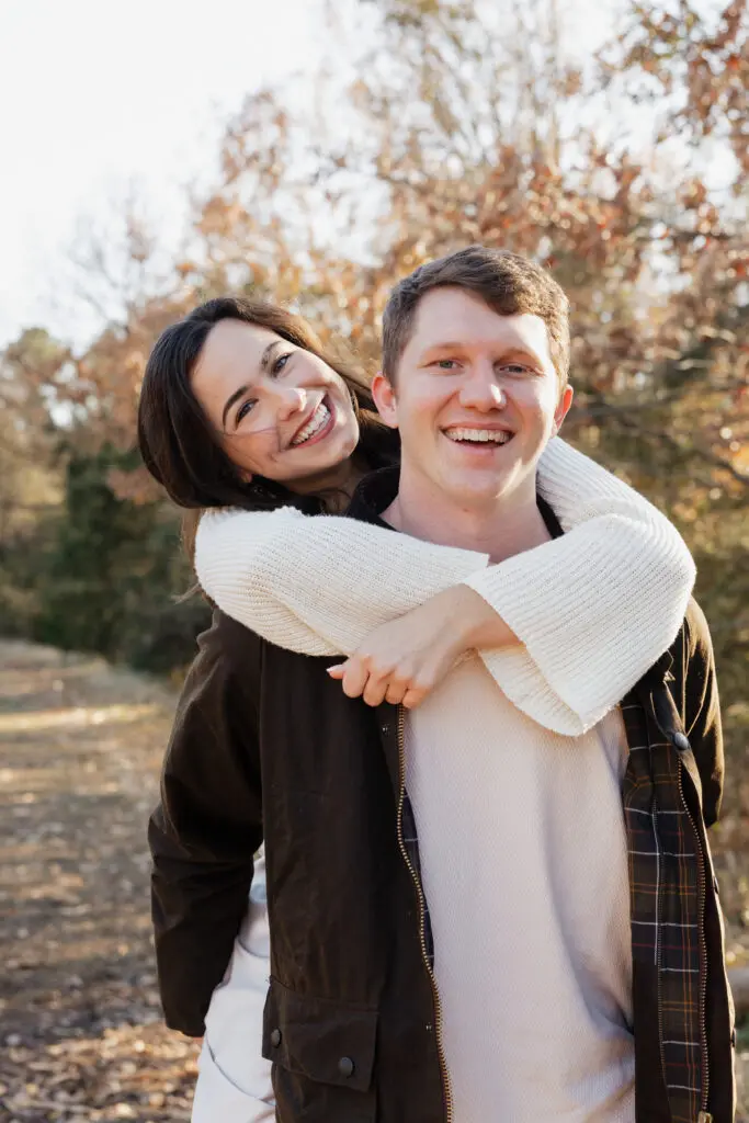 Close-up of a couple leaning together in a field at Bells Mill Park, Chesapeake, Virginia, with soft natural surroundings.