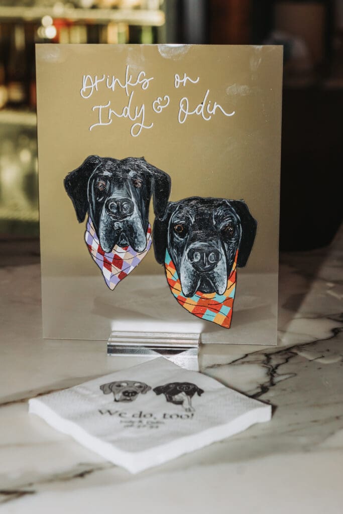 A wedding drink sign featuring two great danes that says 