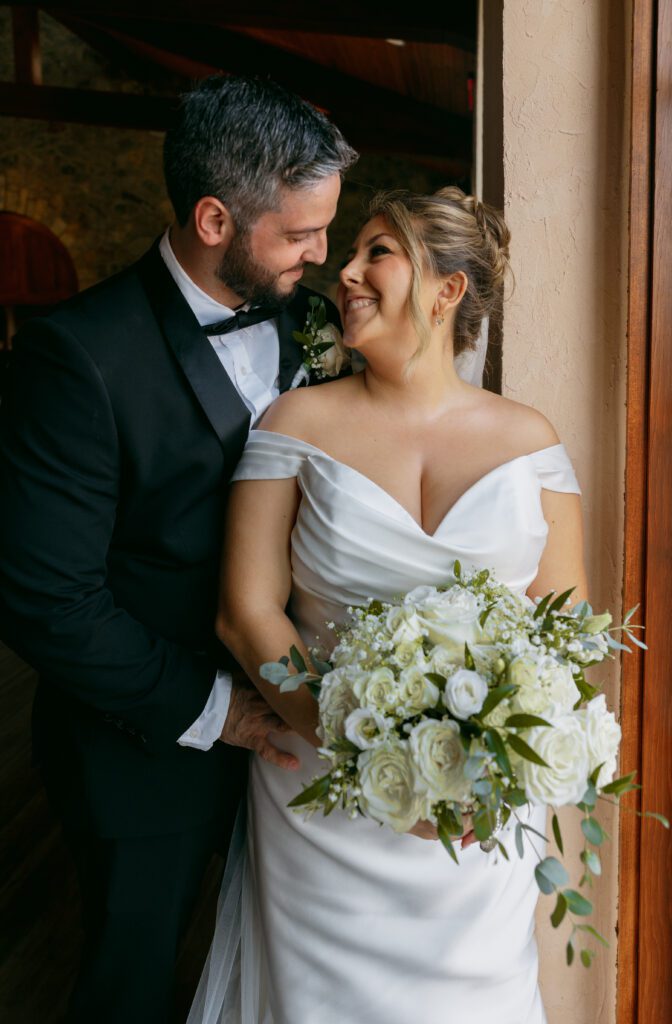 Bride and Groom inside cuddled up immediately after their wedding ceremony