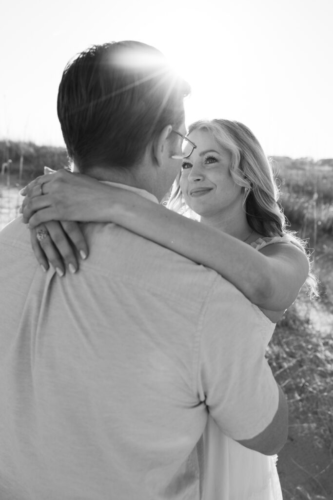 Black and white photo of a couple embracing and staring into each other's eyes