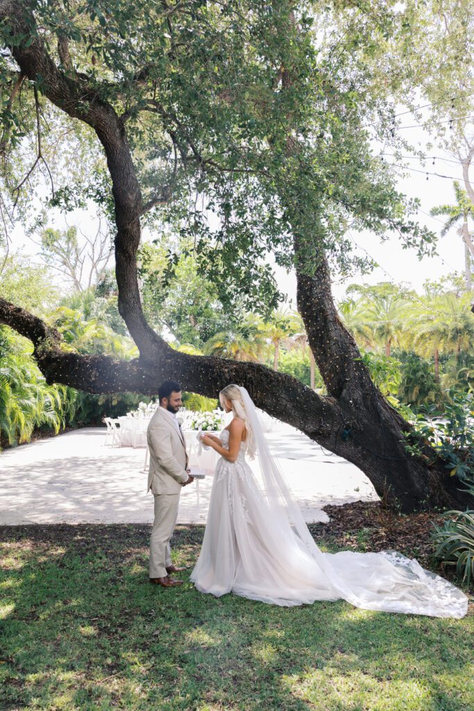 Groom and bride taking first look portraits at the alderman house in florida
