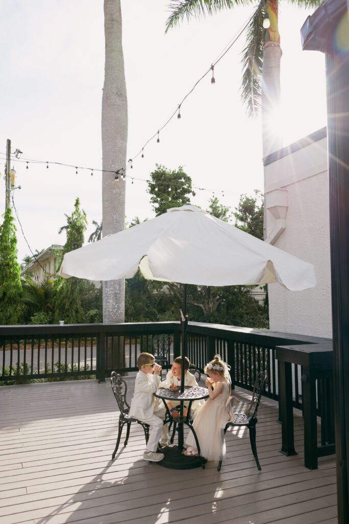 Flower girls and Ring bearer sitting at a table during the reception