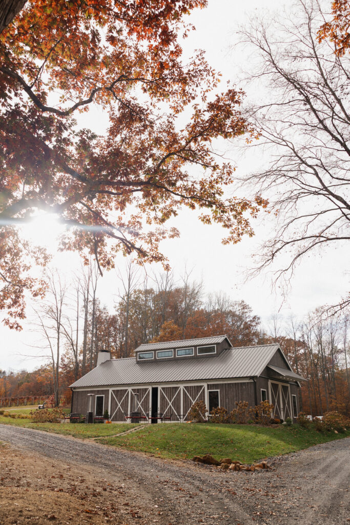 Beautiful shot of the lovingston winery wedding venue featuring the bard and fall foliage