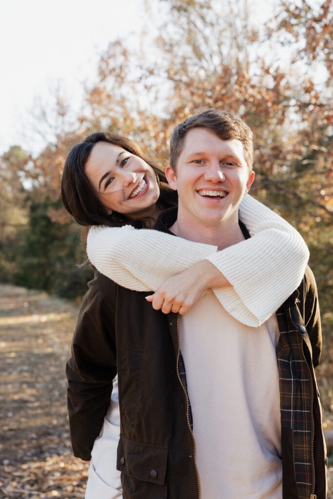 Close-up of a couple leaning together in a field at Bells Mill Park, Chesapeake, Virginia, with soft natural surroundings.