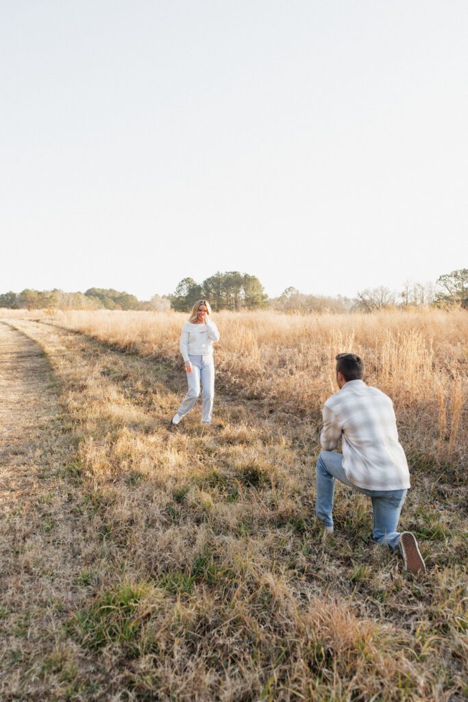 Romantic winter engagement session of a couple in neutral attire at Bells Mills field in Chesapeake, Virginia.